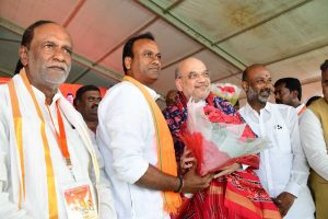 BJP leader and Union Home Minister Amit Shah welcoming former Congress MLA Komatireddy Rajagopal Reddy to the party at a rally in Munugode 