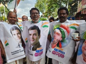 Members of Kerala Congress' Thiruvananthapuram beach mandalam pose with Rahul Gandhi flex banners fashioned into a cape. South First/Anusha Ravi Sood.