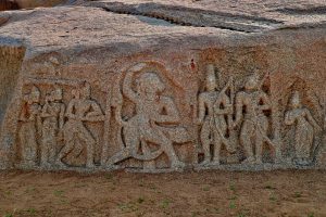 Sculptures of deities carved on a rock in Hampi 