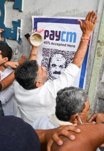 KPCC President DK Shivakumar along with LoP Siddaramaiah pasting 'PayCM' posters in Bengaluru on Friday. (Supplied)