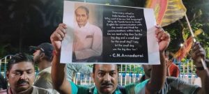 A man displaying CN Annadurai poster at the Bangla Bokkho protest against hidi imposition in Kolkata