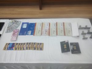 Seized items - foreign exchanges in INR and USD, passports, stamps, debit and credit cards, and bank books. (Ajay Tomar/South Fist)