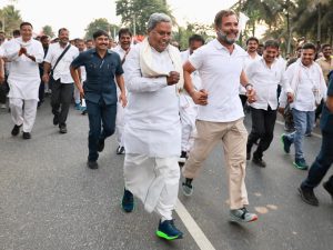 Former Karnataka CM Siddaramaiah runs hand-in-hand with Rahul Gandhi at Bharat Jodo Yatra on Thursday. (Supplied)