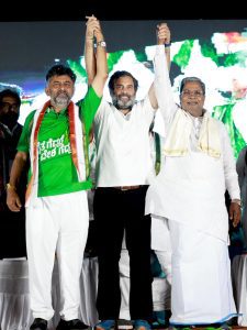 Rahul Gandhi holding DK Shivakumar and Siddaramaiah's hands in a show of unity at Raichur on Saturday. (Supplied)