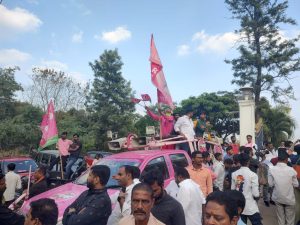 The aged man unfurling the TRS flag on Isuzu hi-lander car modified and colored pink.
